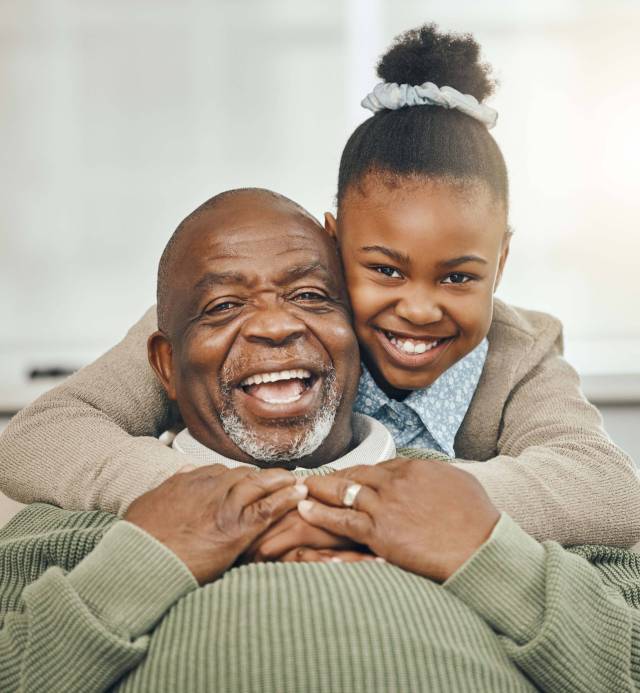 My precious papa. Shot of a grandfather bonding with his young granddaughter on a sofa at home